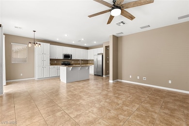 Kitchen/Family room area featuring a ceiling fan,