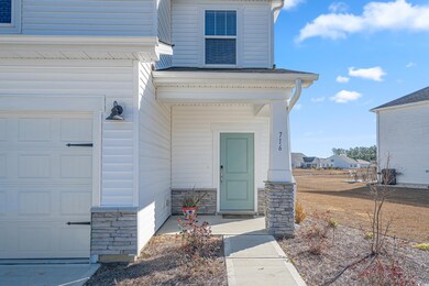 View of exterior entry featuring a garage
