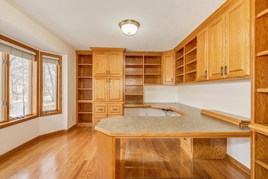 The ultimate Office. There's an abundance of shelves and cabinets, along with a built-in desk.
