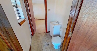Bathroom with vanity, toilet, and tile patterned f