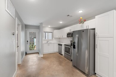 Kitchen with visible vents, a sink, concrete floo