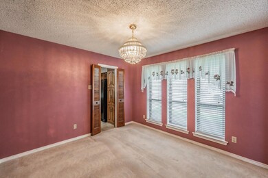 Unfurnished room with baseboards, carpet flooring,