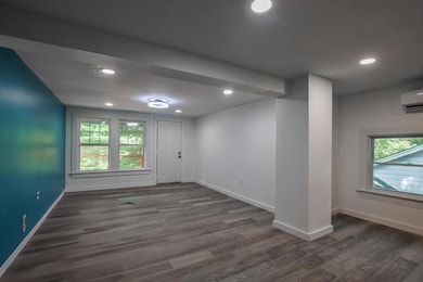 Foyer with wood finished floors, recessed lighting, plenty of natural light, and a wall mounted air conditioner