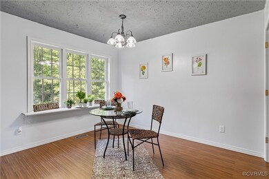 Dining room featuring wood-type flooring, a textur