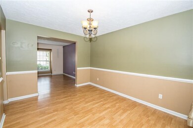 Sizable formal dining room looking into formal liv