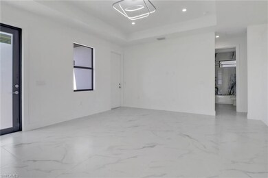 Spare room featuring a tray ceiling