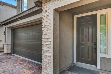 Entrance to property with a garage, stucco siding,