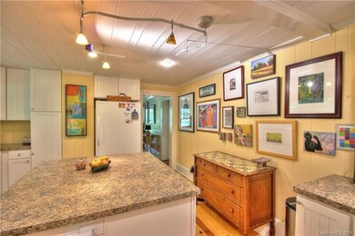 Kitchen features period heart pine flooring.  Gorg