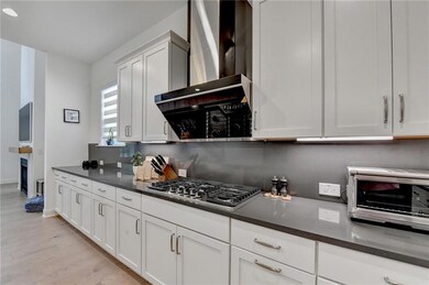 Kitchen featuring light wood-type flooring, stainl