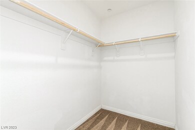 Primary bedroom walk-in closet