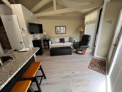 Living room with light wood-style flooring and baseboards
