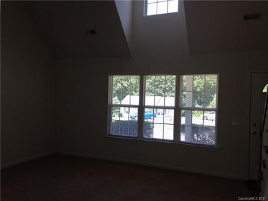 The living room is spacious and sunny.