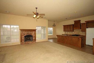 Living room with fireplace,two large windows. Open