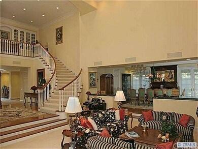 Sweeping stair case with library at landing