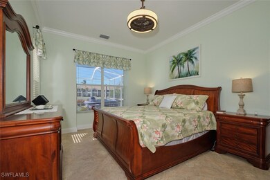 Bedroom with ornamental molding, light tile patter