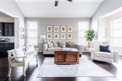 The light and bright den is graced with sunlight from multiple scenic windows with more of the rich  flooring. What a lovely and cheerful space to spend time in with your family and friends!