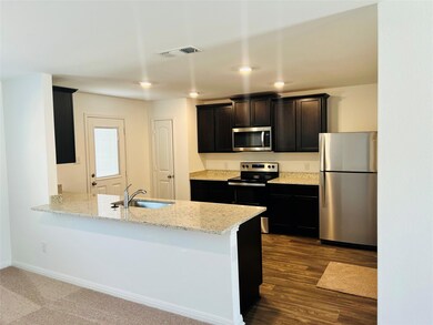 Kitchen featuring stainless steel appliances, lig