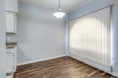Unfurnished dining area featuring dark wood-type f