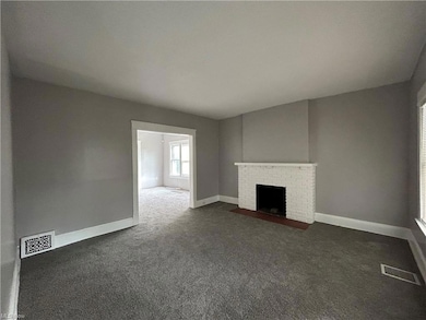 Carpeted living room with a fireplace