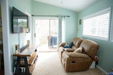Living area featuring light colored carpet and lof