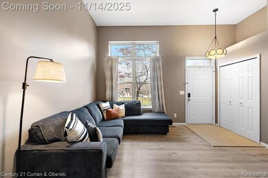Living room with bright window, updated flooring, new paint, and fireplace