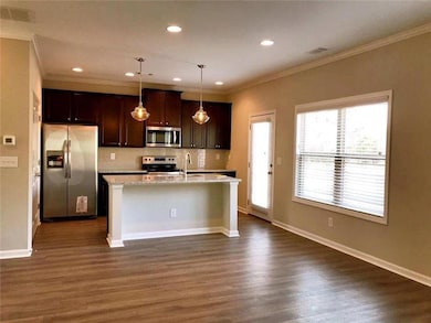 Kitchen with recessed lighting, a sink, dark wood 
