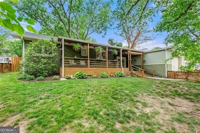 Back of house with a fenced backyard, a ceiling fan, a lawn, and brick siding