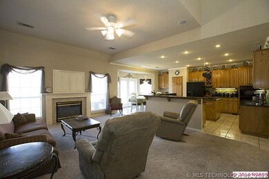 Great room adjacent to kitchen features a gas fireplace and bookcases.  carpet is 4 years new.