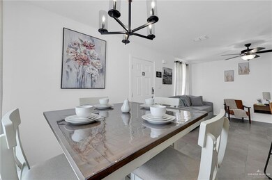 Dining space with a chandelier and a ceiling fan