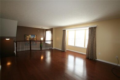 Living room with hardwood floors. Large window wit