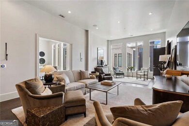 Living area featuring wood finished floors and recessed lighting