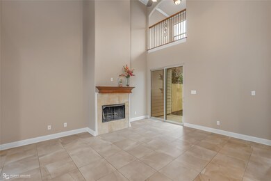 living area with high ceilings and fireplace