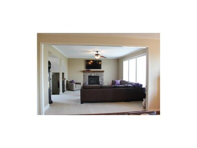 Great room w/ stone fireplace and Silhoutte blinds