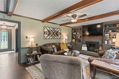 Living room featuring ornamental molding, a firepl