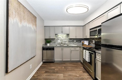 Kitchen featuring stone countertops, stainless ste