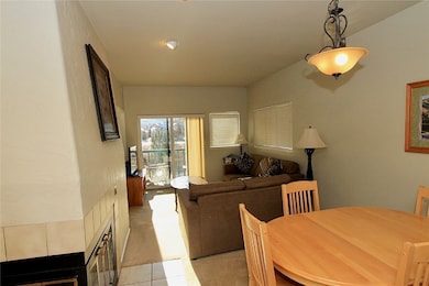 Dining area with light carpet and a textured wall