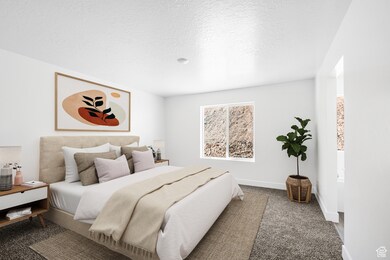 Bedroom featuring carpet flooring and a textured ceiling