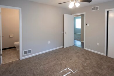 Unfurnished bedroom with connected bathroom, ceili