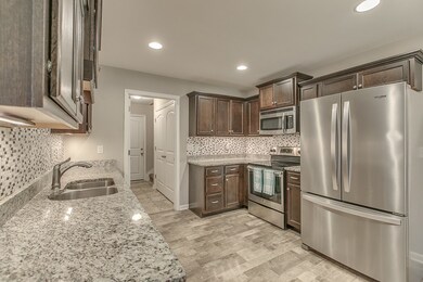 Kitchen with stainless appliances and granite counters