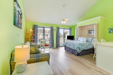 Bedroom with ceiling fan, access to outside, hardw