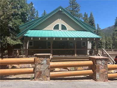 View of front of house with a porch, metal roof, a
