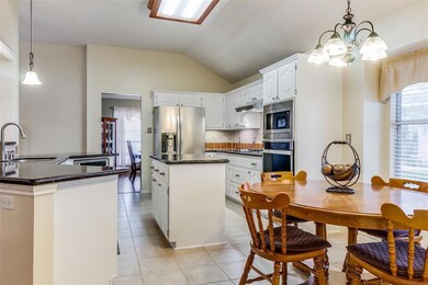 Large kitchen island and adjacent breakfast area.