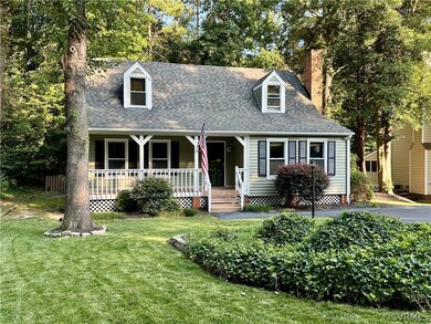 New england style home featuring a porch and a fro