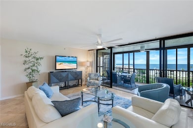 Living room featuring a wall of windows and ceiling fan
