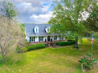 Cape cod-style house featuring a porch and a front