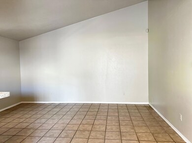 Tiled empty room with baseboards