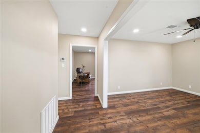 Unfurnished room with dark wood finished floors, ceiling fan, and recessed lighting