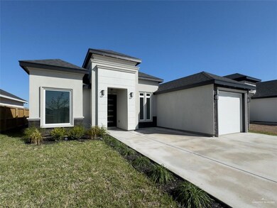 View of front facade with a garage and a front lawn