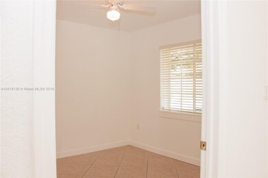 The second bedroom has a fan and a beautiful windo