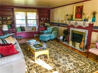The living room boasts a wood burning fireplace an